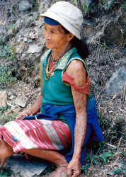 10 tattooed woman sitting on the side of the road 800