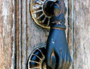 1 Old brass hand door knocker on an old door in Guatemala 800