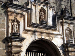 11 religious sculptures over an entrance of a ruined church in antigua