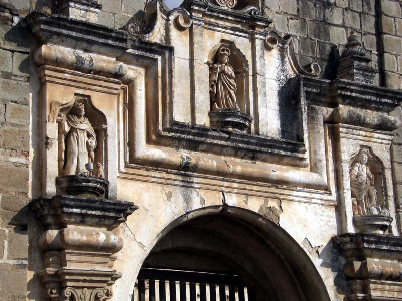 11 religious sculptures over an entrance of a ruined church in antigua