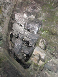 39 mayan face carved in stone at tikal